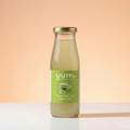 Bottle of yumi green tea and lemongrass on a gradient background