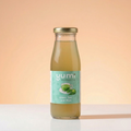 Bottle of yumi kombucha green tea and mint flavor on a peach background